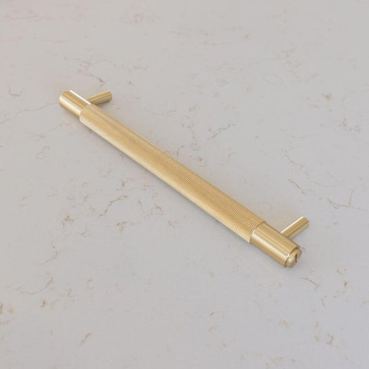 Buster and Punch Brass Pull Bar Cabinet Handle on grey flecked background