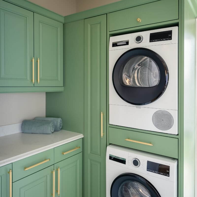 Gold Cabinet Handles on Sage Green cabinetry in utility room