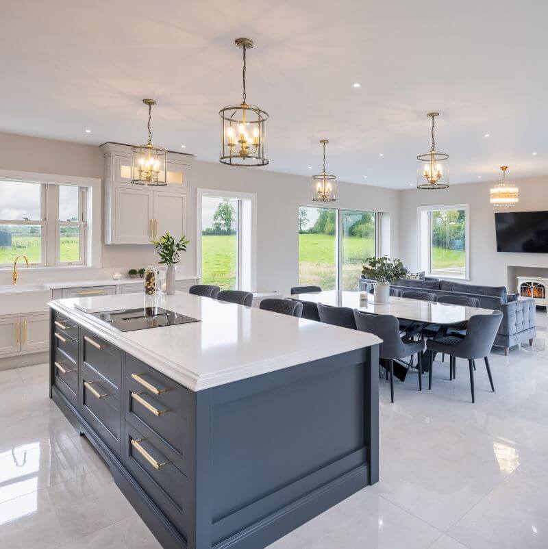 Luxury Kitchen showing Brass Buster Punch handles on navy island cabinetry