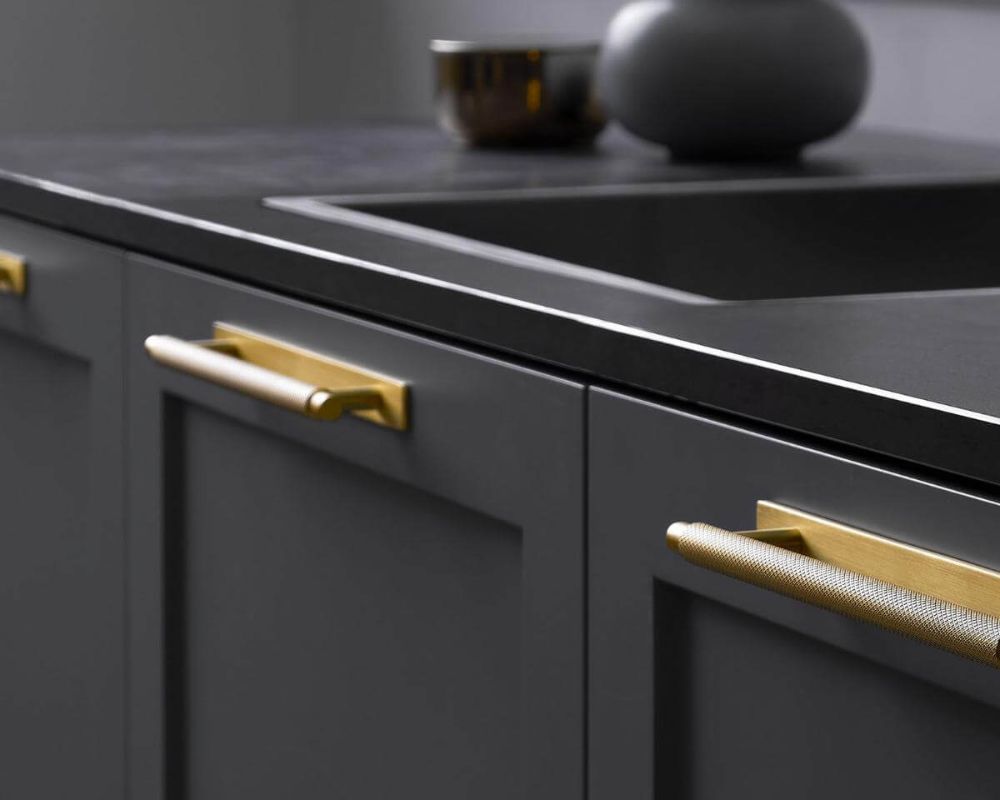 Elegant Gold finish kitchen cabinet handles with back plate on dark coloured cabinets