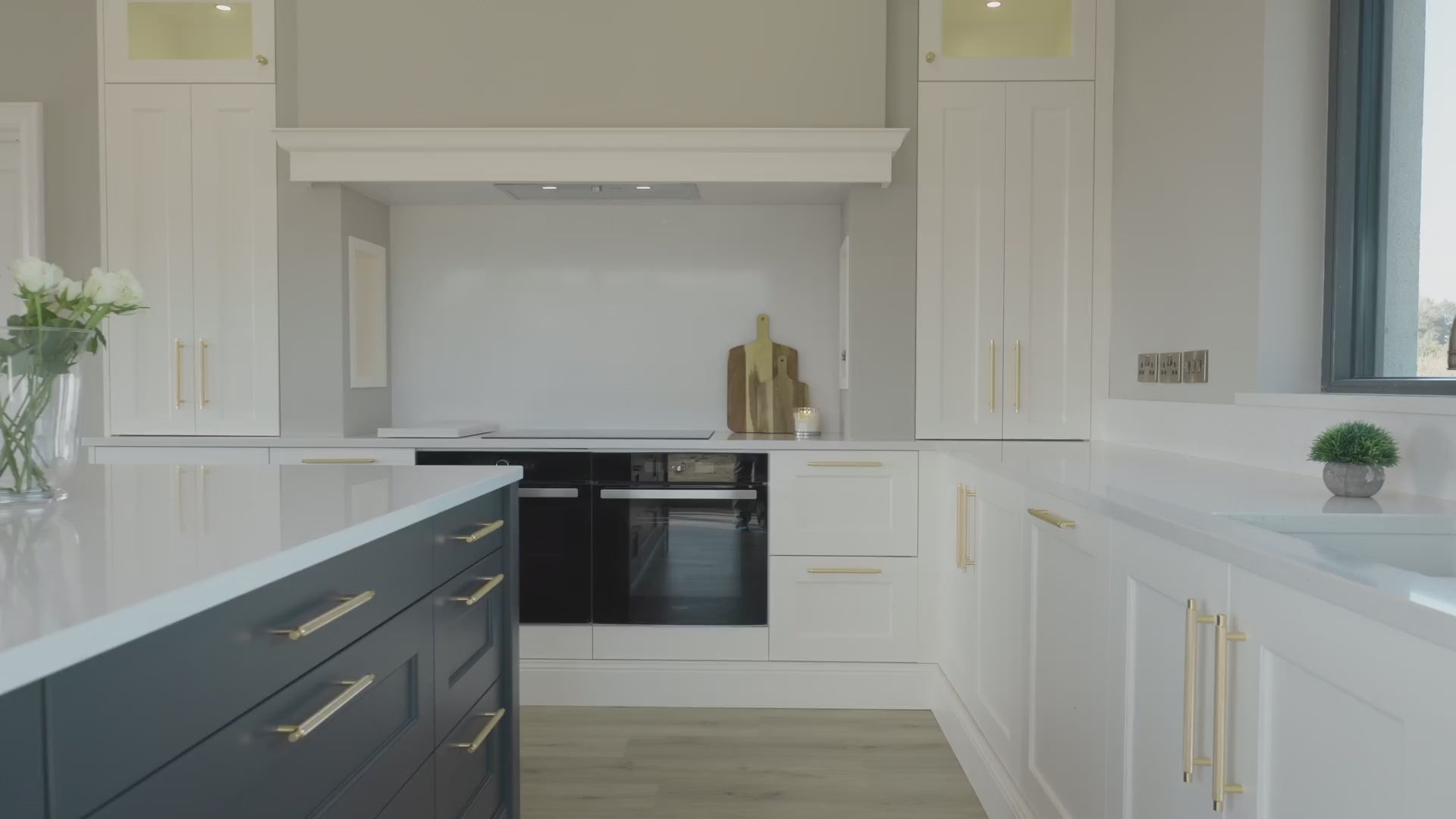 Load video: Video showing close up images of Gold handles on off white and navy cabinetry in a newly completed kitchen